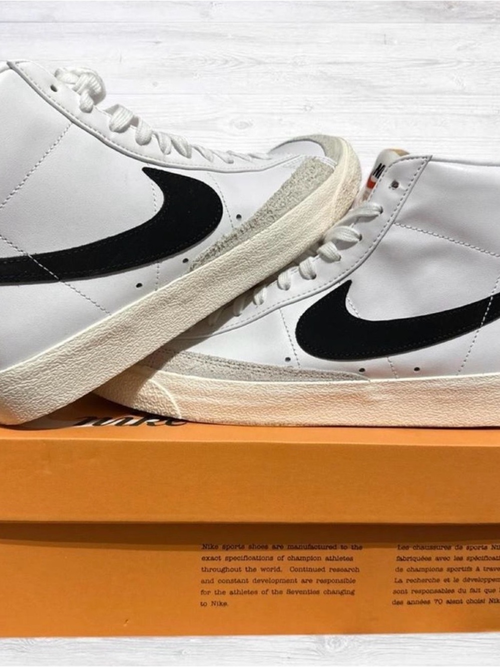 Nike White High-Top Sneakers with Black Swoosh